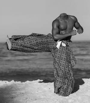 Showing his strong male body on the beach