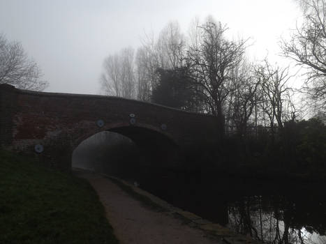 Bridge over foggy water