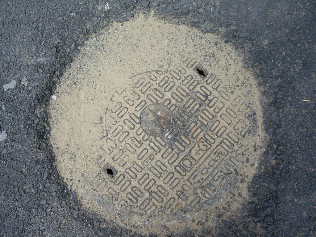 Manhole Of Electricity Equipment Covered With Dirt