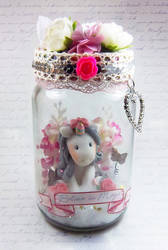 Unicorn figurine in a jar