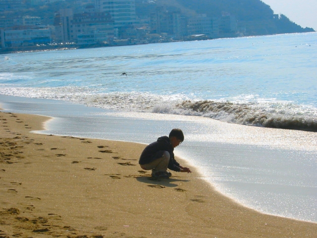 boy playing in the sand, Korea