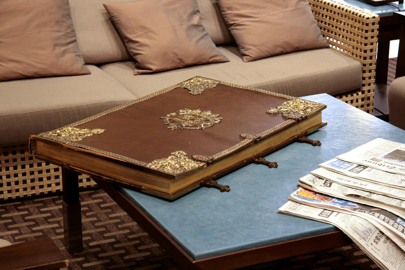 Huge old leather book on table