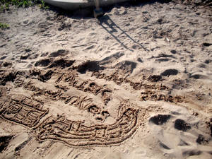 Music Junkies written in sand