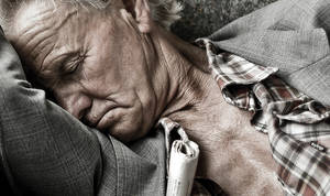 old man sleeping in a bus