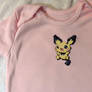 Pichu cross-stitched pink baby onesie