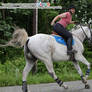 Looking and Reaching Back While Riding Horse Away