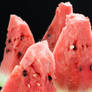 Sliced watermelon over dark background