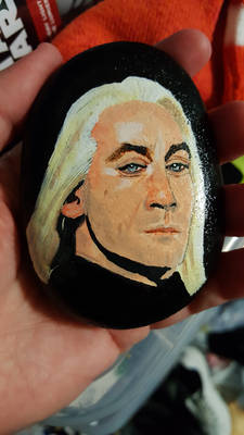 Lucius Malfoy from Harry Potter on a rock