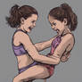 Two young girls wrestling
