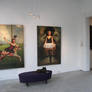 Paintings are hung in the gallery