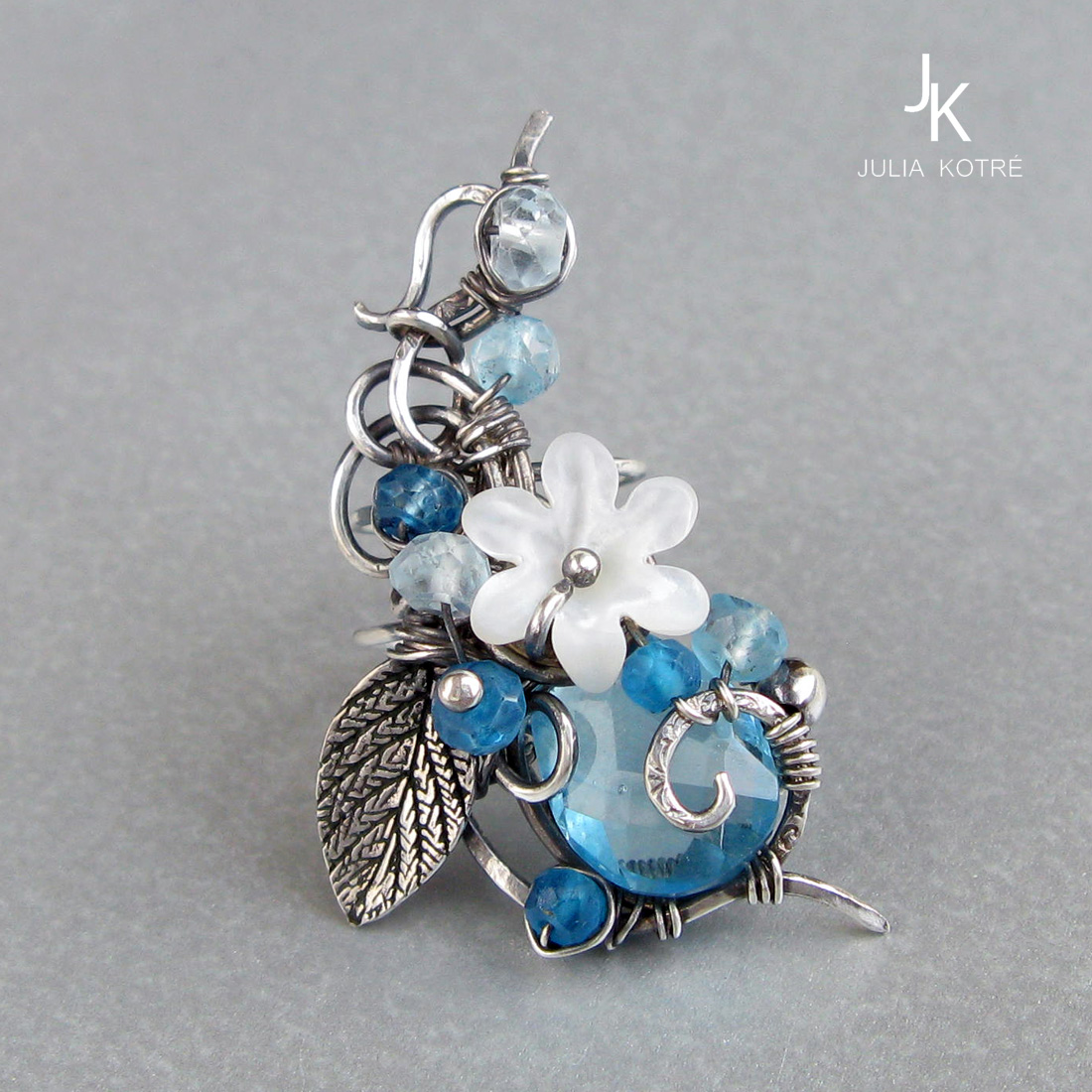 silver floral ear cuff with blue gemstones