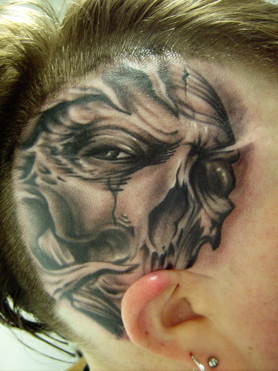 Freehand skull on head tattoo