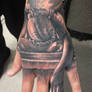 statue hand tattoo