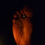Relaxed god feet sitting in the dark