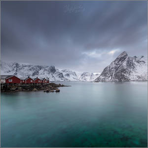 Norwegian landscape with cabins and a mountain