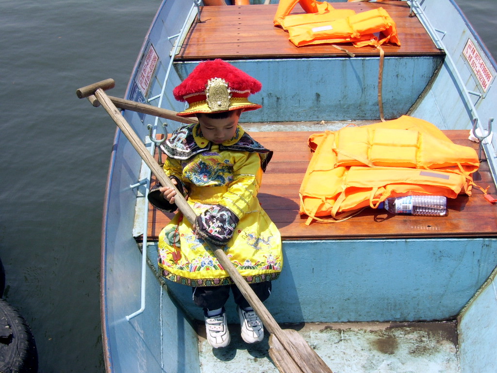 Little Prince Captaining A Boat