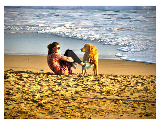 Girl with a dog in the beach.