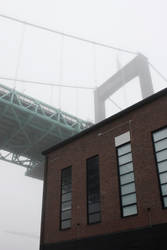 Brickwall house under a bridge in the mist