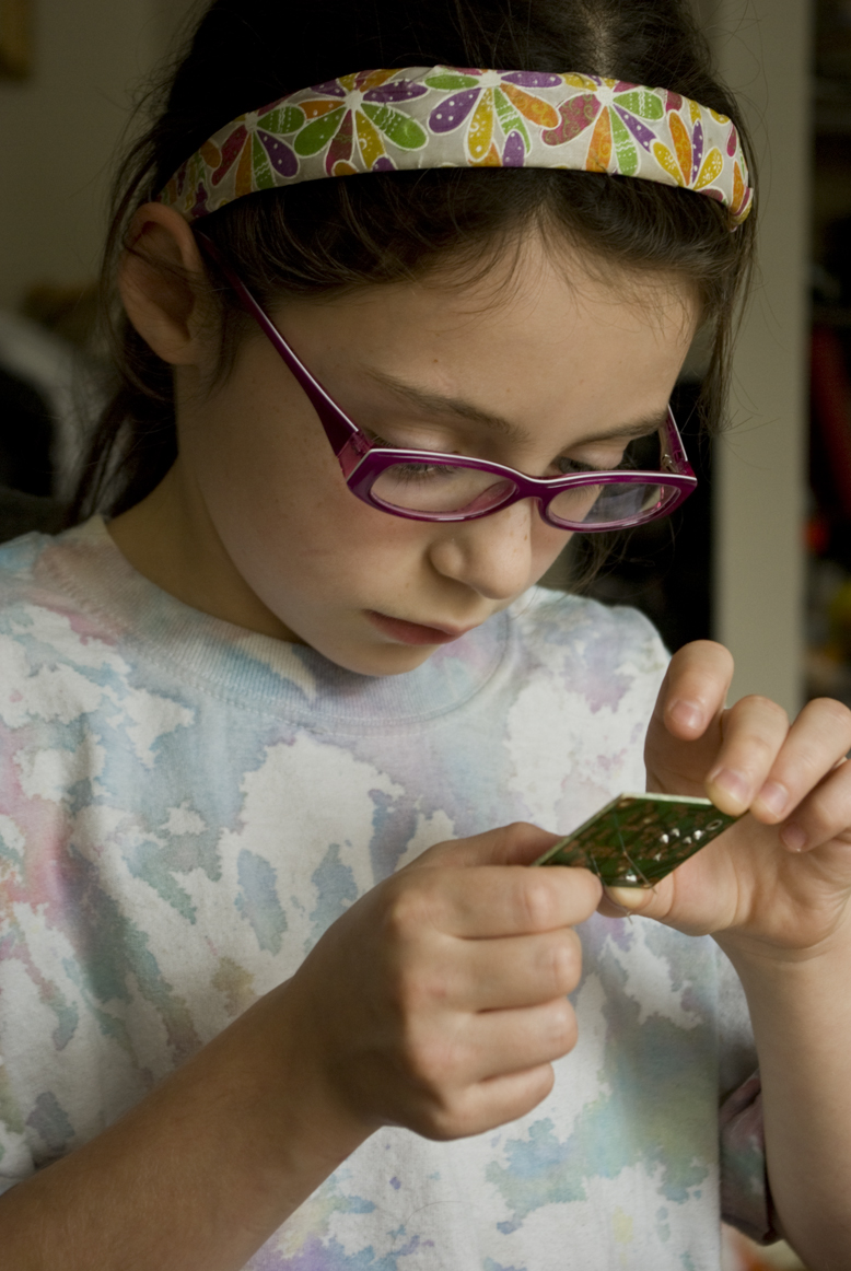 Soldering: Inspecting her work