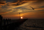 silhouettes at the pier by VaggelisFragiadakis