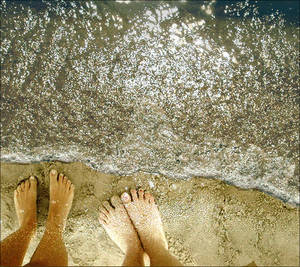 Feet in the sand on the beach