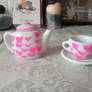 Teapot and cup with hearts