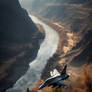 Fighter aircraft flying over canyon and river