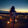 Woman watching at starry sky and sunset