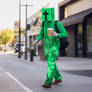 Person in Creeper Minecraft costume, with coffee