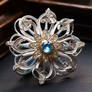 Silver flower with blue crystals
