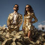 Couple in golden clothes, standing in banknotes
