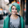 Girl with turquoise hair, in headphones, in street