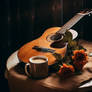 Acoustic guitar and cup on wooden table