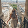 Woman walking down stairs in Paris