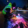 Guy painting with luminescent colors on road