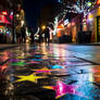 Colourful stars painted on night street road