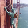 Statue of liberty climbing Golden Gate bridge