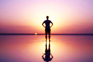 Defocused silhouette of a lone person reflected