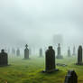 Medieval graveyard shrouded in thick dense misty f