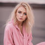 Cute feminine blonde girl in pink clothes 