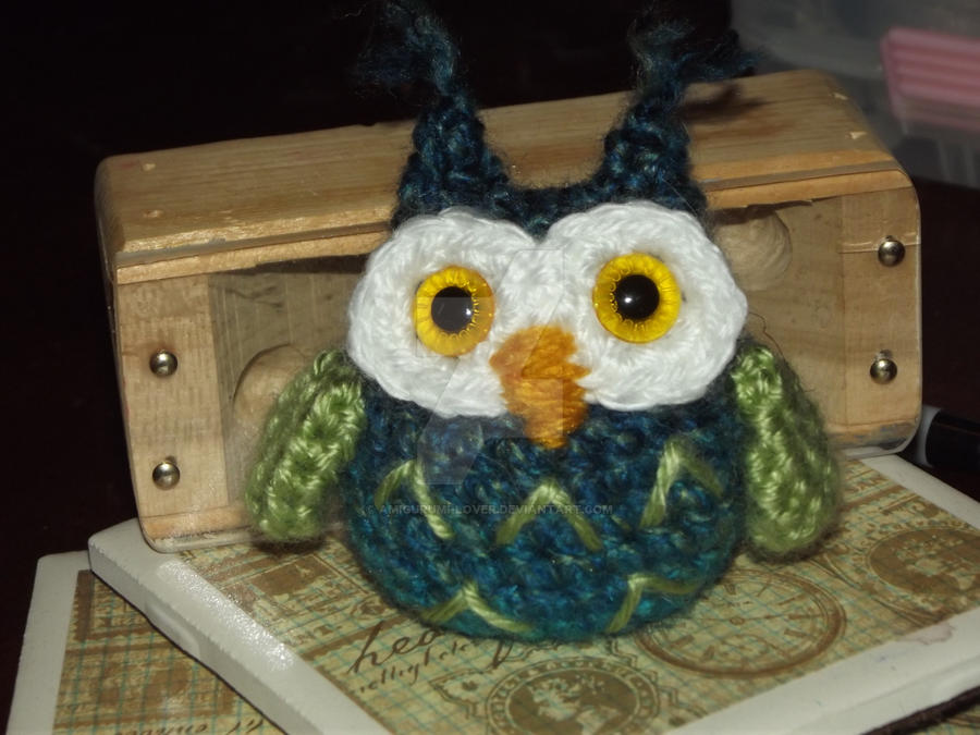 Blue and green owlet with yellow eyes