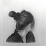 Young girl modeling the bun of her hairstyle