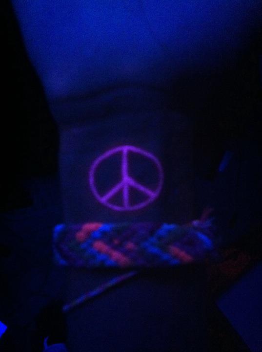 Peace sign black light tattoo