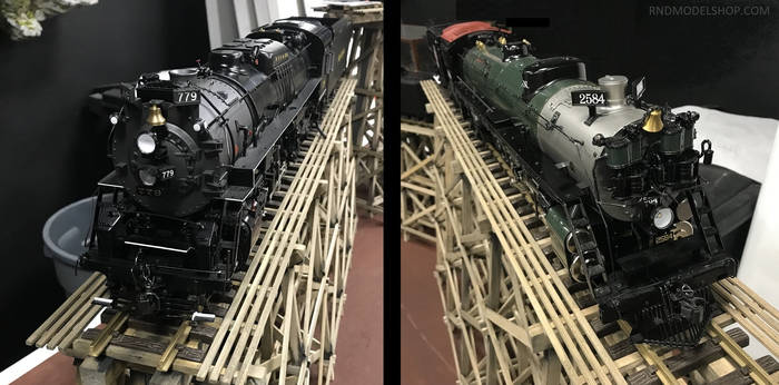 Two Brass Model Trains on Wood Trestles display
