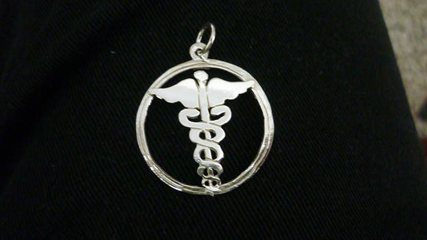 Caduce dije de plata