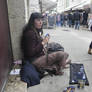 Barefoot gypsy selling in street