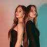 MJ: Twins stands back to back in black dresses