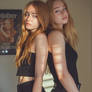Redhead Girls in black outfits posing back to back