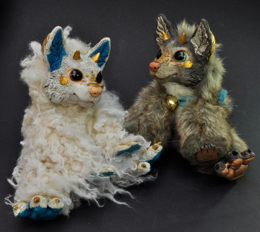 Two resin dragon-foxes