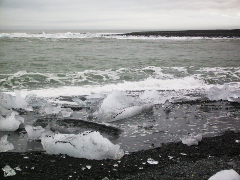 Ice cubes on black sand.